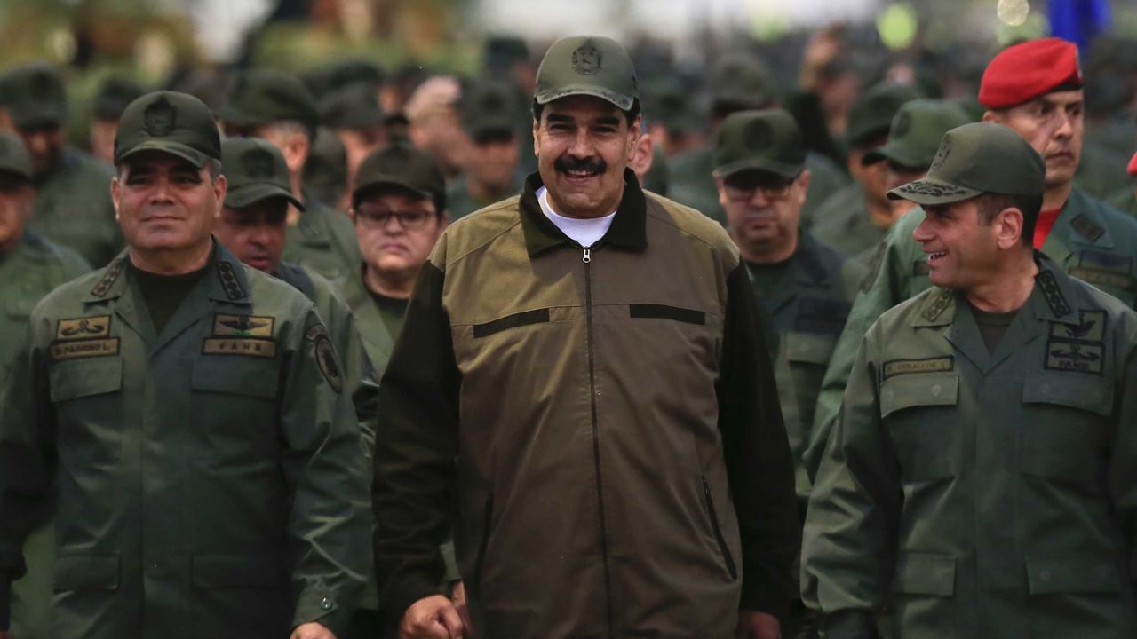 In this handout photo released by Miraflores Press Office, Venezuela's President Nicolas Maduro, center.