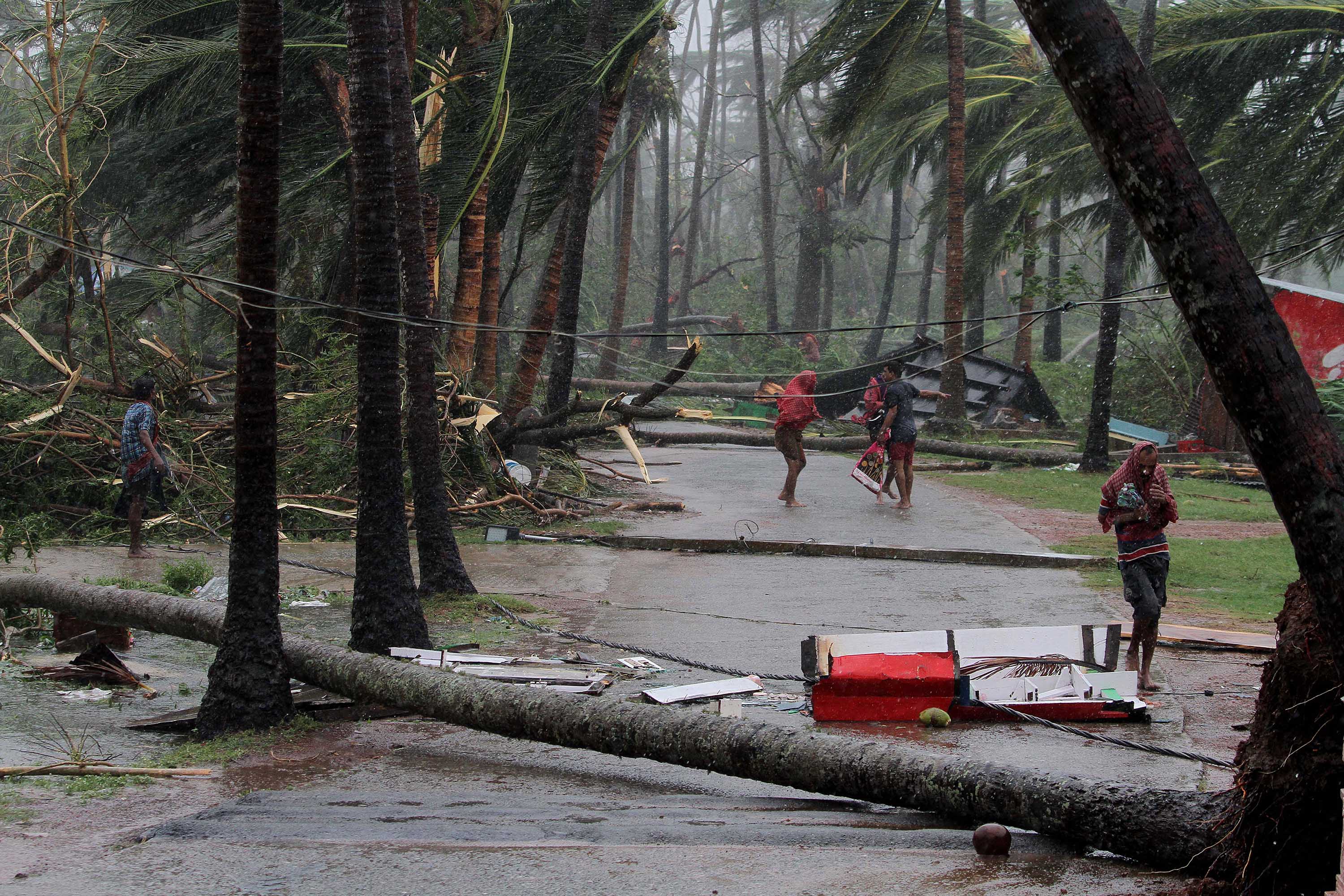 People run for shelter after Tropical Cyclone Fani made landfall near Puri, India, on Friday, May 3.