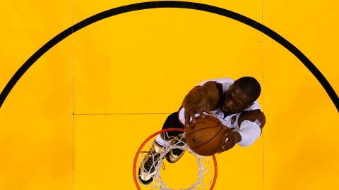 Dwyane Wade is pictured dunking the ball.