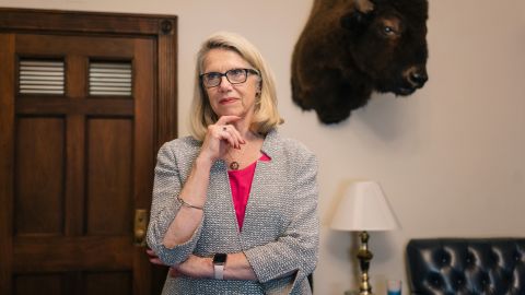 Rep. Carol Miller stands in front of "Marshall," a bison head in her office on Capitol Hill. She owns a bison farm in her home state of West Virginia.