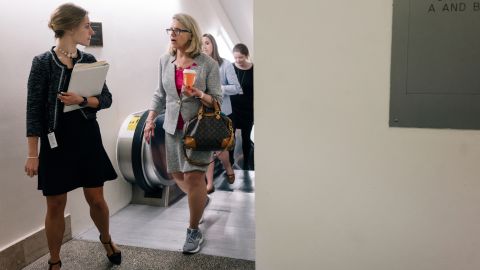 Miller talks to legislative aide Jacquelyn Incerto while walking back to her office.