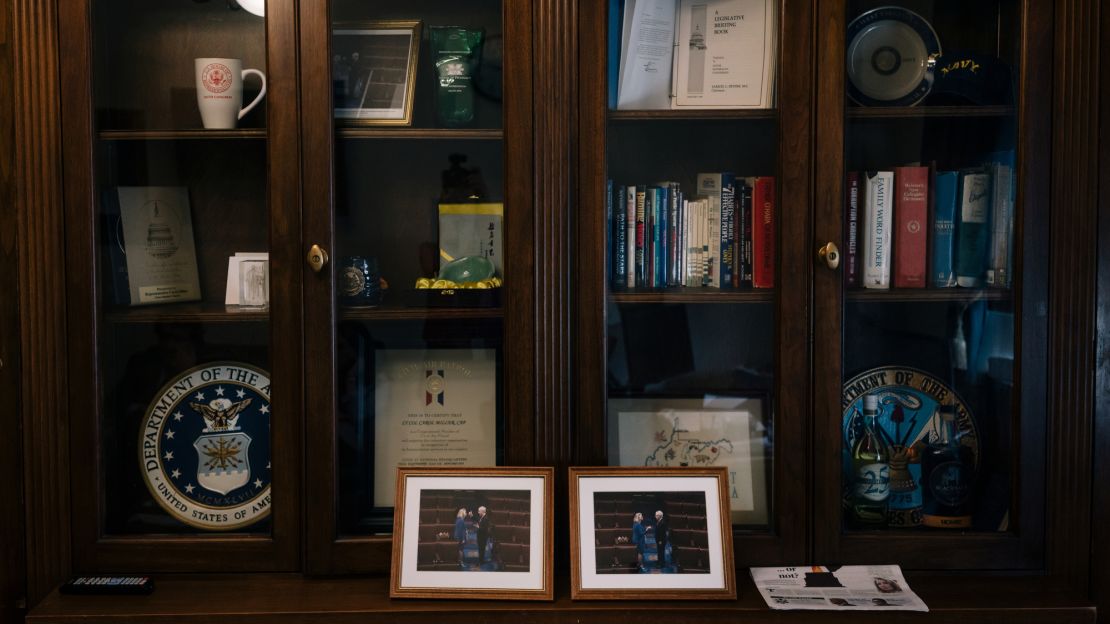 Photos of Miller with Sen. Mitch McConnell sit on the bookshelf in her office.