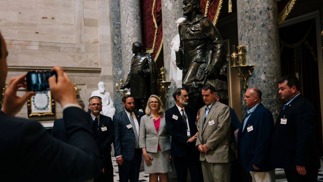 Miller takes a photo with members of the West Virginia State Building and Construction Trades Council in the Capitol building's Statuary Hall.