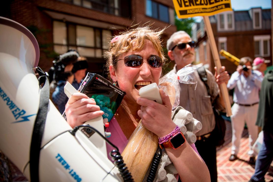 Members of the anti-war group Code Pink try to bring supplies inside the building after Venezuelans blocked entrances.