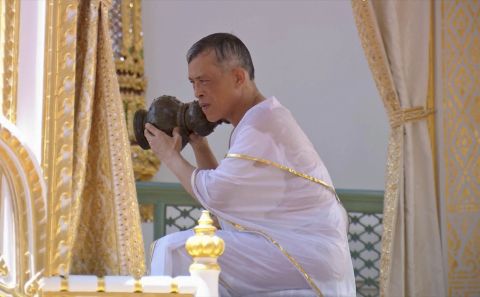 King Maha Vajiralongkorn takes part in the royal purification ceremony at the Grand Palace. Holy water from symbolic vessels is poured over the King's back and into his hands. Some of the water vessels contain holy water collected from all 76 provinces around the country.