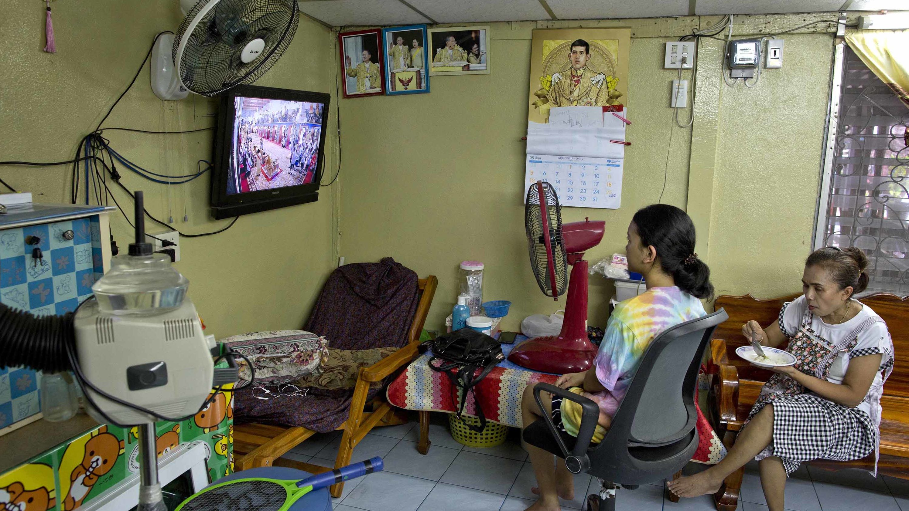 People in a beauty salon watch a live broadcast of the coronation ceremony.