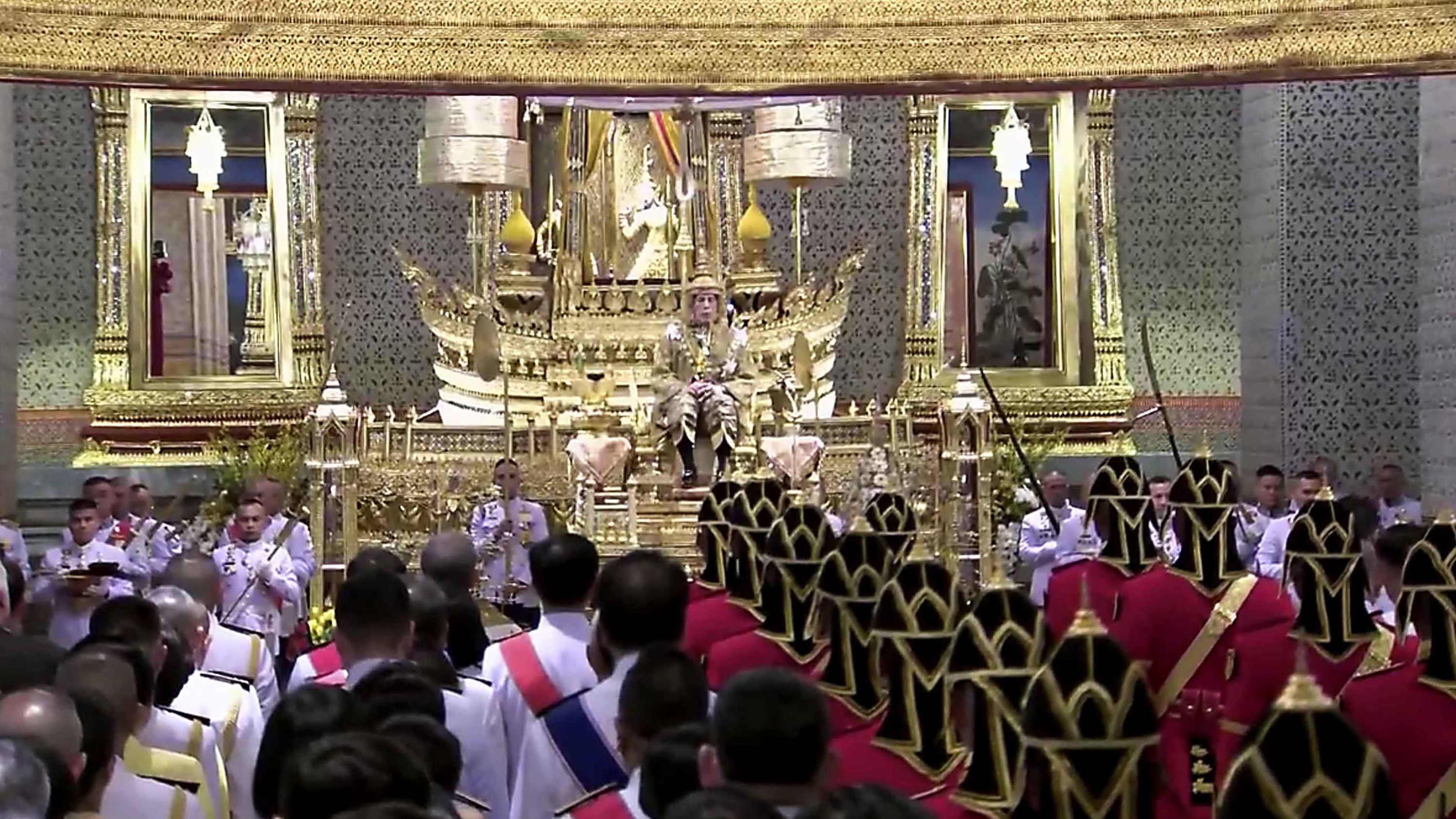 King Vajiralongkorn sits on the throne before an audience of diplomats and dignitaries at the Grand Palace on May 4.
