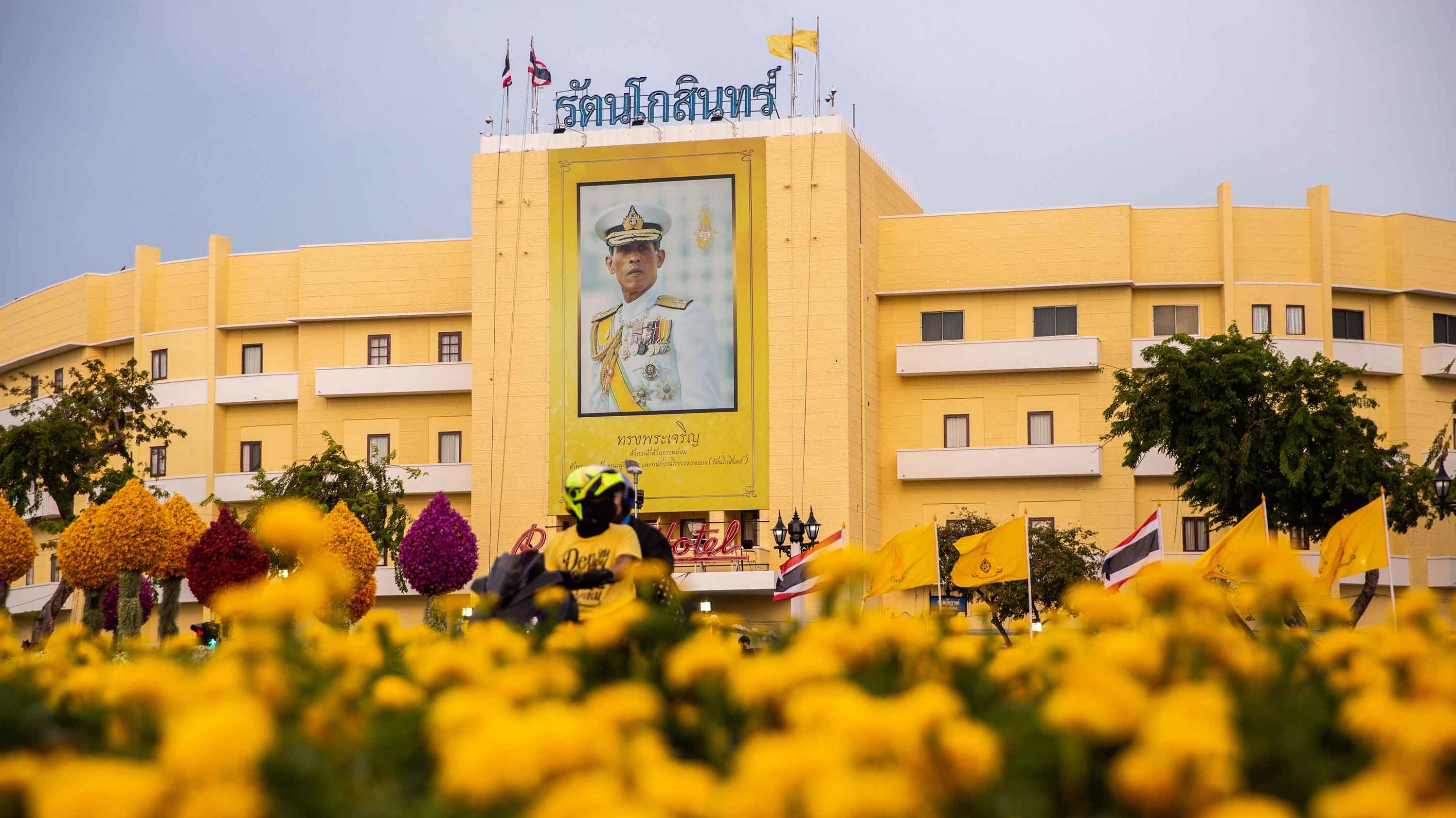 A portrait of King Maha Vajiralongkorn hangs near Thailand's Royal Palace ahead of the coronation on May 3. The color yellow is associated with the day of the King's birth -- Monday. In Thailand, every day of the week corresponds to a color.