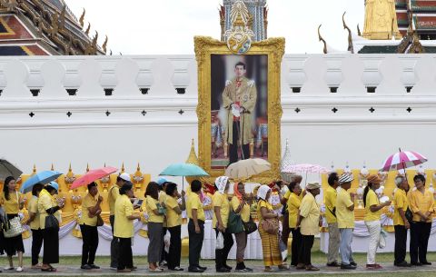 Well-wishers line up in front of a portrait of King Vajiralongkorn outside the Grand Palace in Bangkok on May 4.