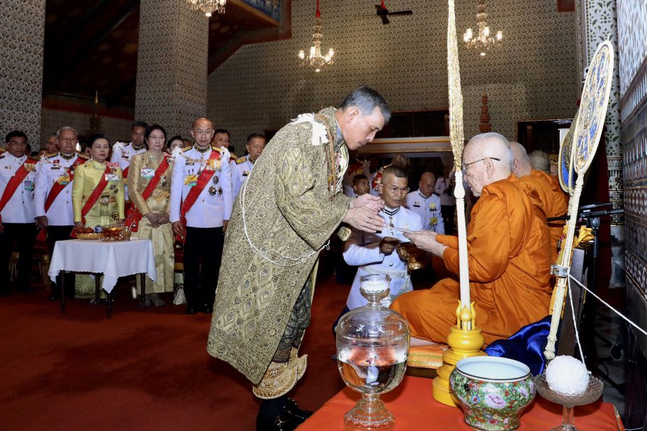 The Thai monarch offers a donation to a senior Buddhist monk at the Grand Palace on May 4.