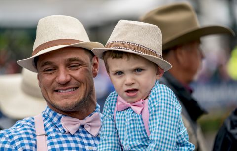 A man and a young boy wear matching outfits.
