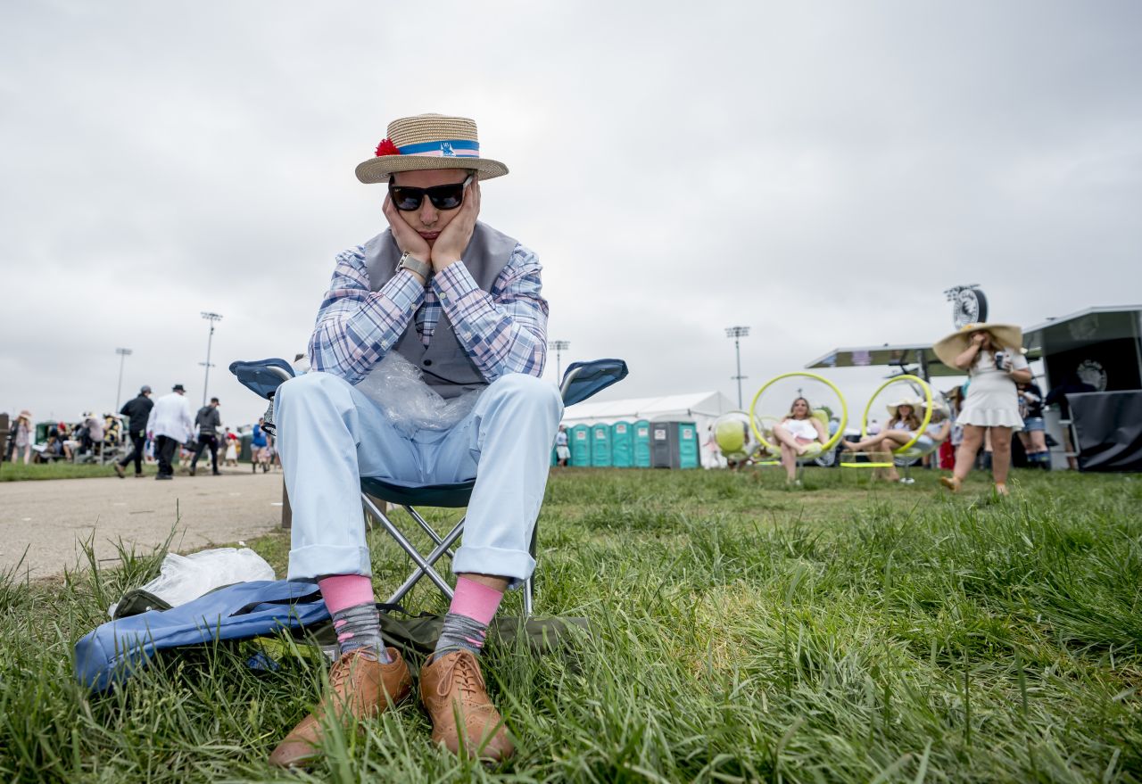 A dejected fan holds his head before the 145th running of the Kentucky Derby.