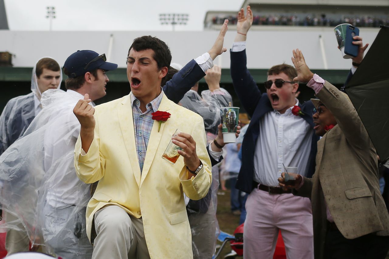 Fans react to a race prior to the Kentucky Derby at Churchill Downs.
