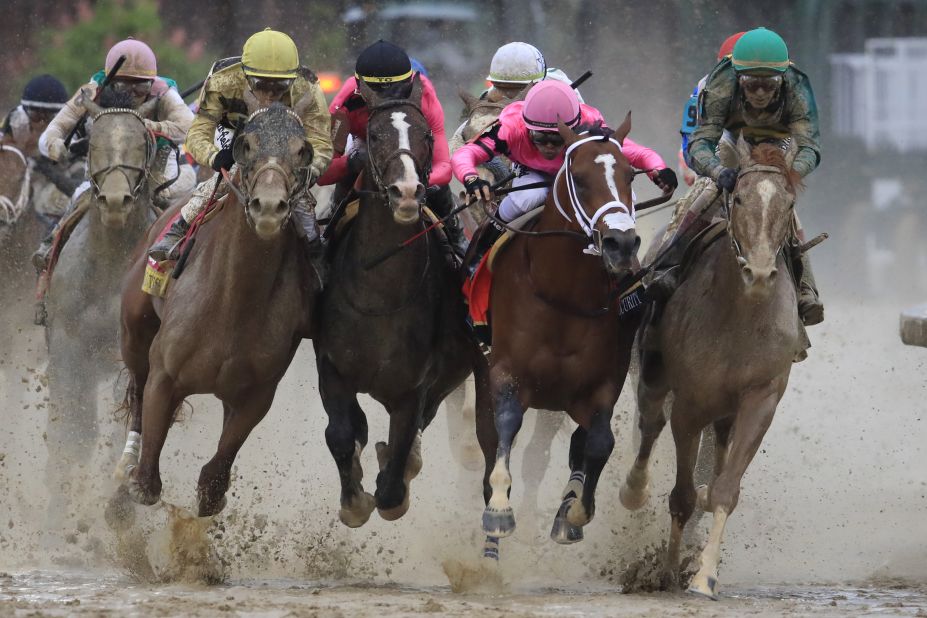 From left, Country House, War of Will, Maximum Security and Code of Honor fight for position in the final turn.