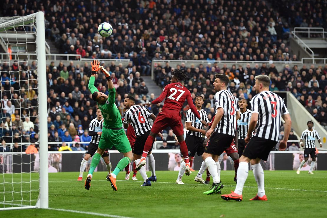 Divock Origi heads home his side's winner in the 3-2 victory at Newcastle.