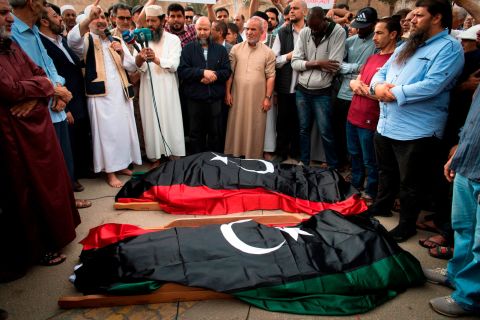 Libyans pray by the bodies of Government of National Accord fighters during their funeral in Tripoli on April 24.