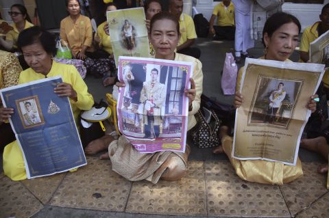 Thai well-wishers hold portraits of Thailand's King Maha Vajiralongkorn outside the Grand Palace on May 5. 