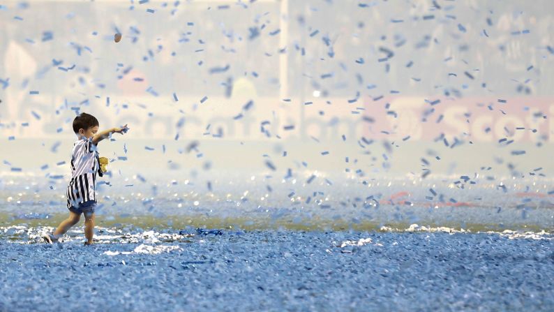 A child wearing a Monterrey jersey plays with confetti after Monterrey defeated Tigres in the CONCACAF Champions League final soccer match, in Monterrey, Mexico, on Wednesday, May 1.