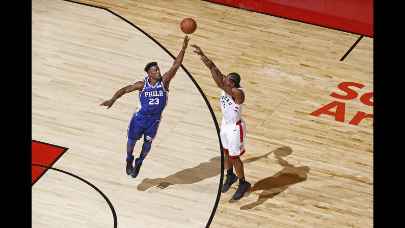 Jimmy Butler of the Philadelphia 76ers, left, contests a shot by Kawhi Leonard of the Toronto Raptors during Game Two of the NBA Eastern Conference Semifinals on Monday, April 29, at Scotiabank Arena in Toronto.