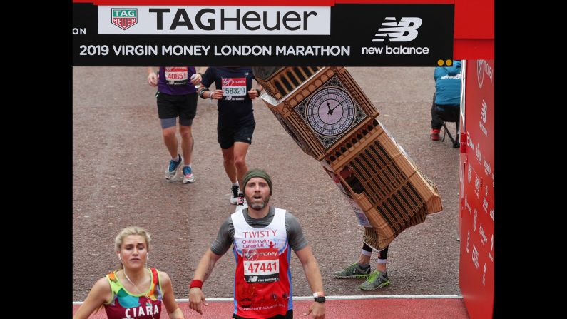 Marathon runner Lukas Bates, dressed in a Big Ben costume, attempts to fit under the finish line of the <a href="index.php?page=&url=https%3A%2F%2Fedition.cnn.com%2F2019%2F04%2F29%2Fsport%2Flondon-marathon-2019-best-stories-spt-intl%2Findex.html" target="_blank">London Marathon</a> on Sunday, April 28.