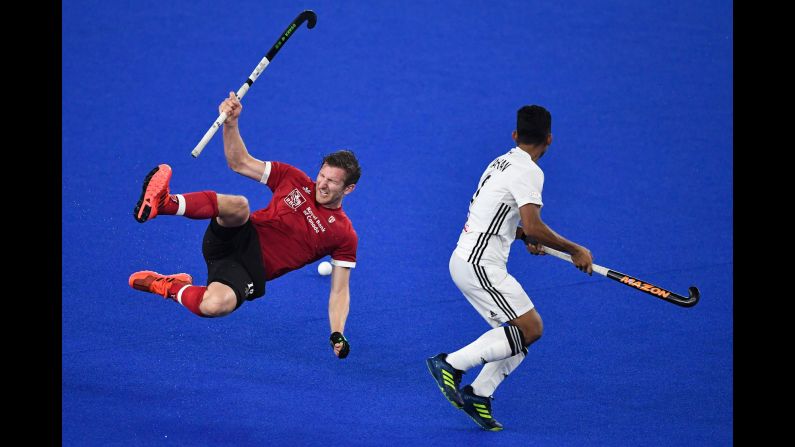 Canada's Mark Pearson, left, falls while competing for a loose ball with Malaysia's Marhan Jalil during the FIH Men's Series Finals field hockey match between Malaysia and Canada on May 4 in Kuala Lumpur, Malaysia. The match was part of a qualifying tournament for the Tokyo 2020 Olympics.