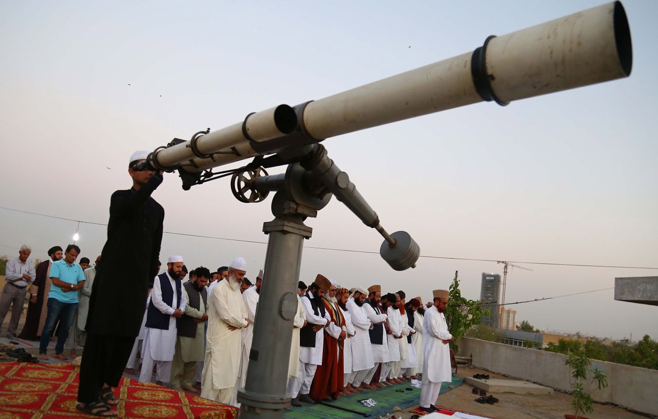 Islamic scholars offer evening prayers as they sight the moon to announce the beginning of the holy fasting month of Ramadan, in Karachi, Pakistan, on May 5.