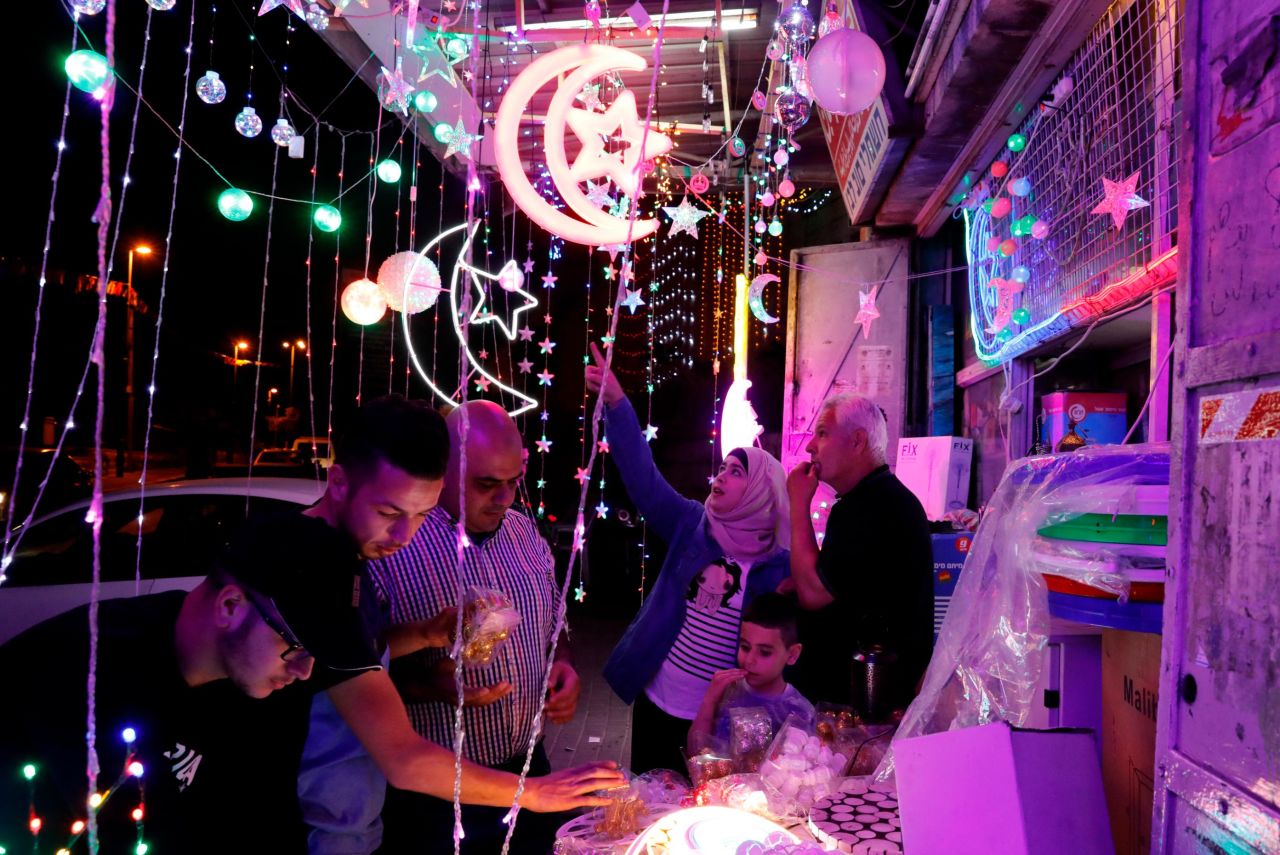 Palestinians check a shop selling Ramadan decoration lights in the old city of Jerusalem on May 4.