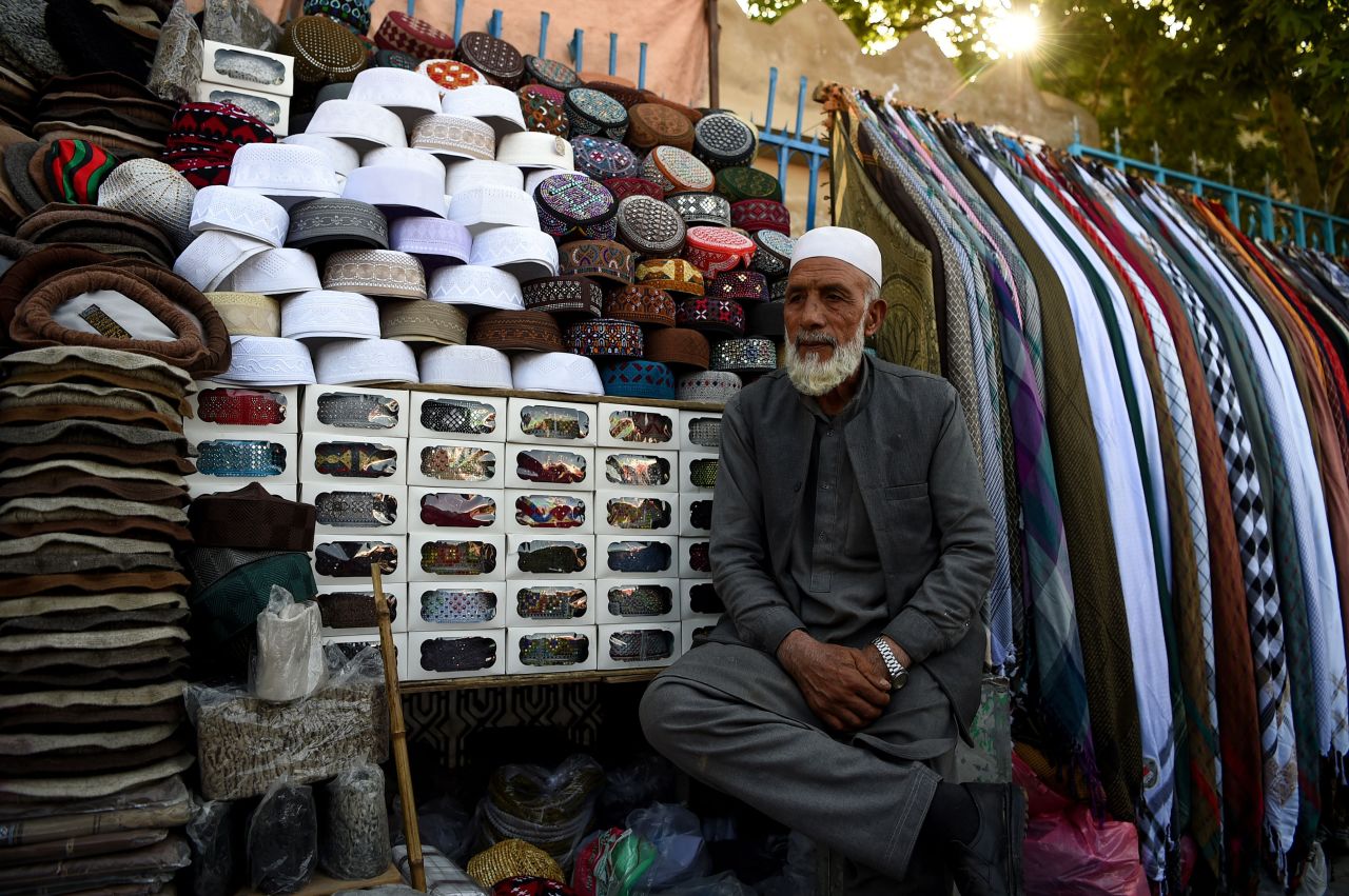 An Afghan vendor looks on as he sells traditional hats at a market stall ahead of the holy month of Ramadan at the Pul-e- Khishti Mosque in Kabul on May 5.