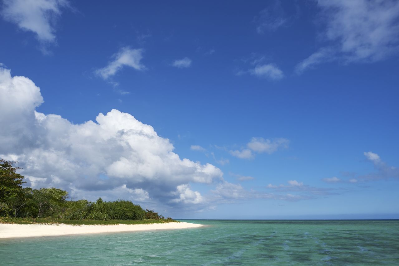 <strong>Shoreline splendor: </strong>White sand beaches stretch around the island, with small forests on the mainland.