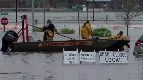 Davenport firefighters used a boat to ferry people from buildings surrounded by floodwaters on Tuesday.