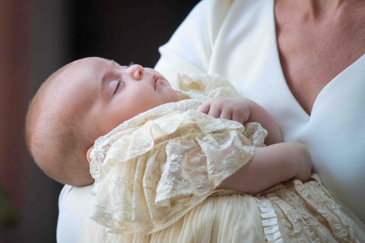 Britain's Prince Louis of Cambridge is carried by his mother, Catherine, Duchess of Cambridge, on their arrival for his christening service at the Chapel Royal, St. James's Palace in London on July 9, 2018. Prince Louis is fifth in line to the British throne.