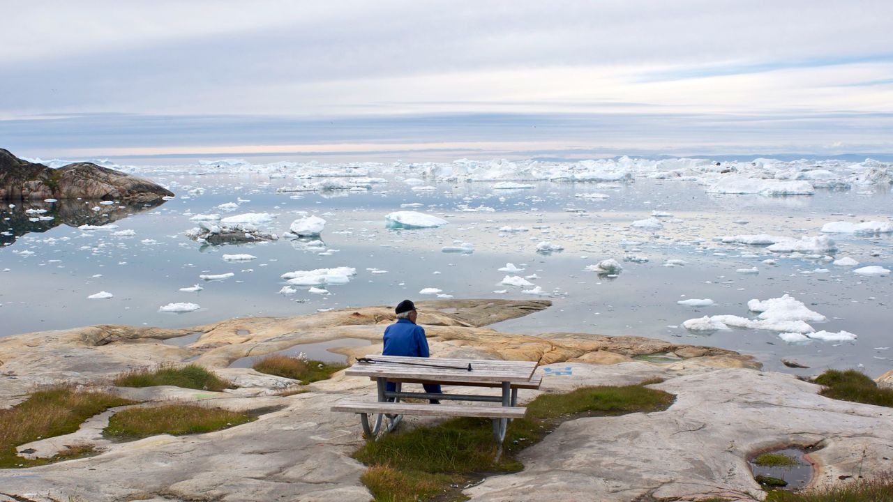 A man takes in  the view over the Ilulissat ice fjord and the Disko Bay in west Greenland. 