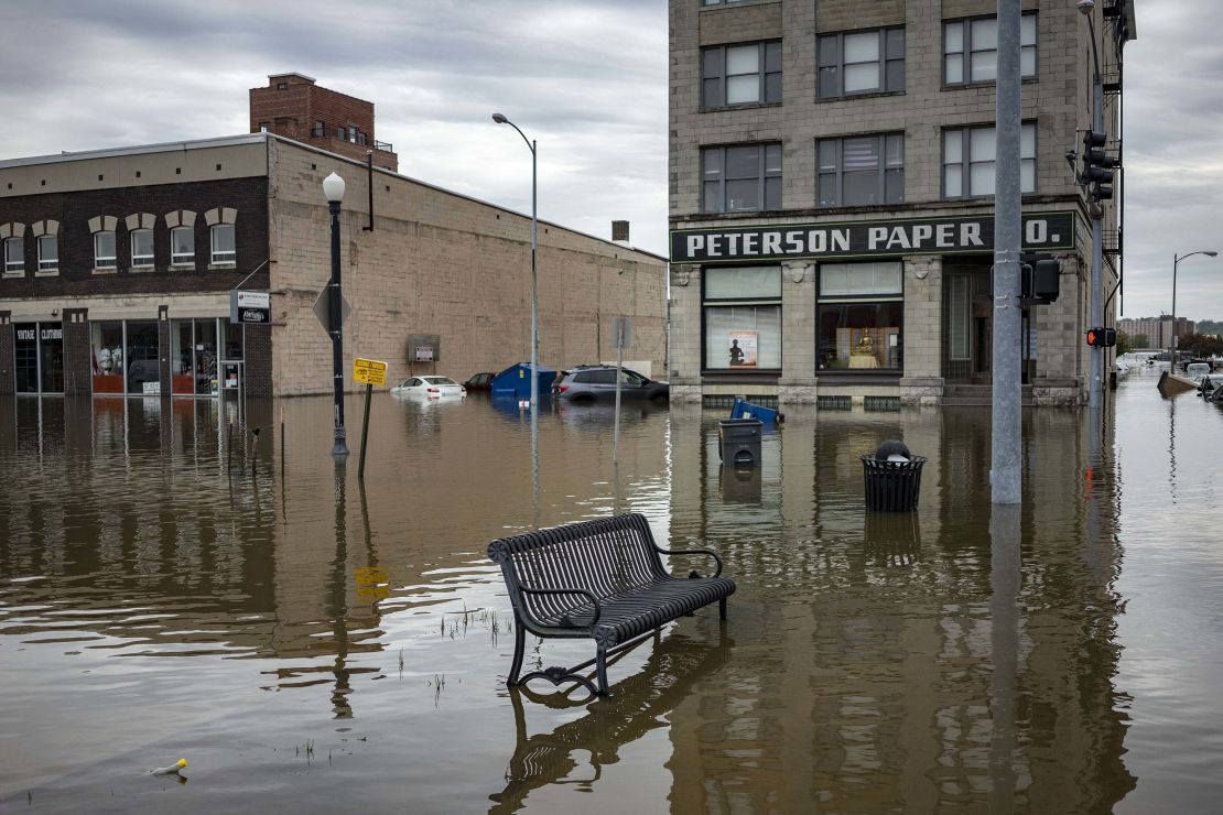 Floodwaters surround a bench near the main breach in the Mississippi River in Davenport, Iowa, on Friday, May 3, 2019.