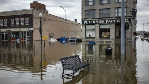 Floodwaters surround a bench near the main breach in the Mississippi River in Davenport, Iowa, on Friday, May 3, 2019.