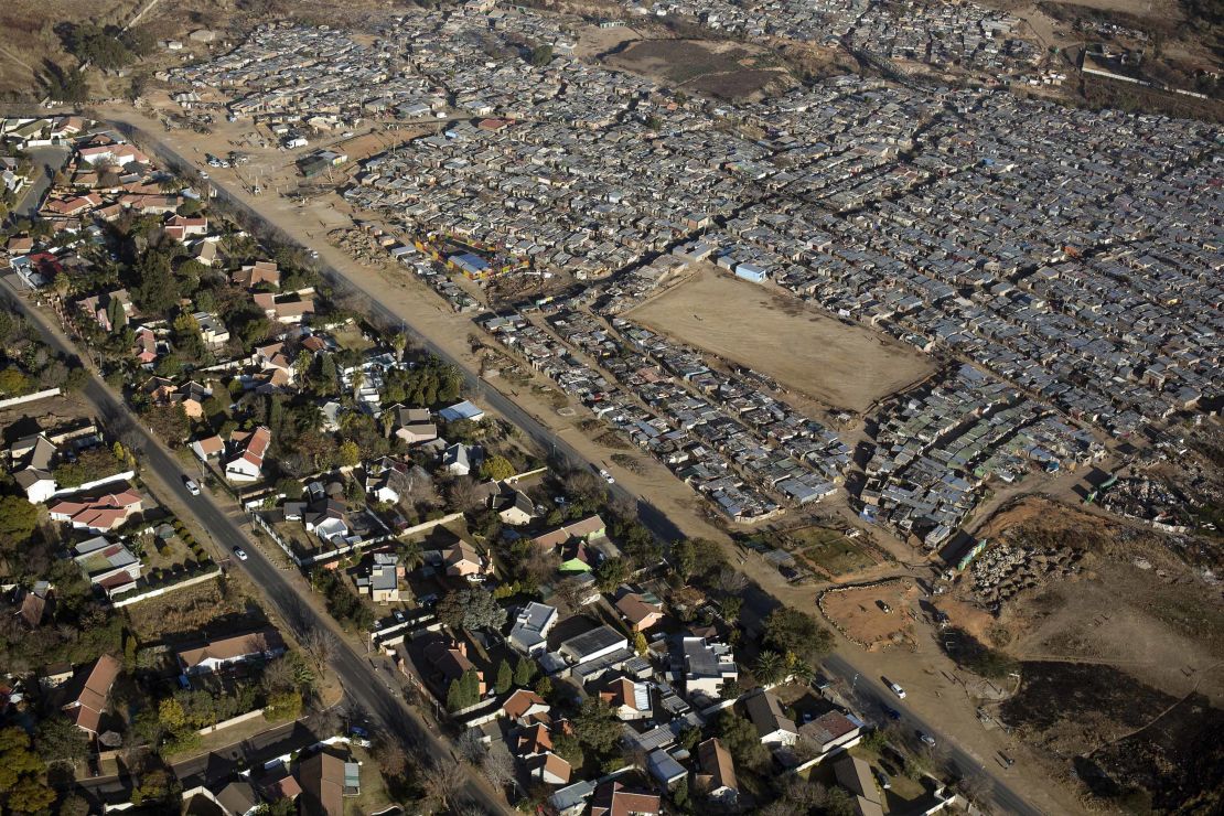 In South Africa, the divide between rich and poor is visible from the sky. On the left is Bloubusrand in Johannesburg, a middle class area with larger houses and pools. On the right is Kya Sands informal settlement.  