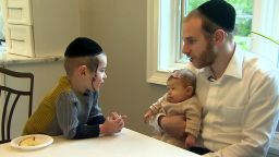 Shimon Singer with his two-month-old daughter, Malky, and son, Dovi.