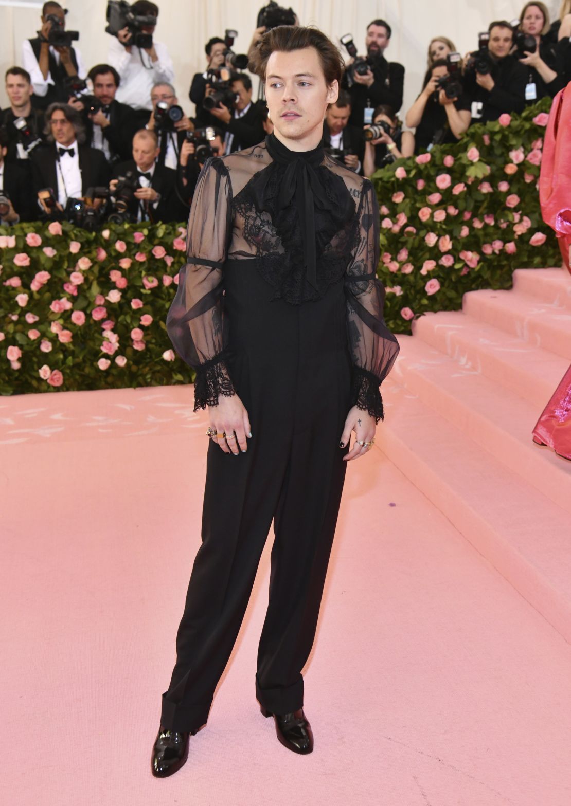 Harry Styles attends the Met Gala wearing Gucci.