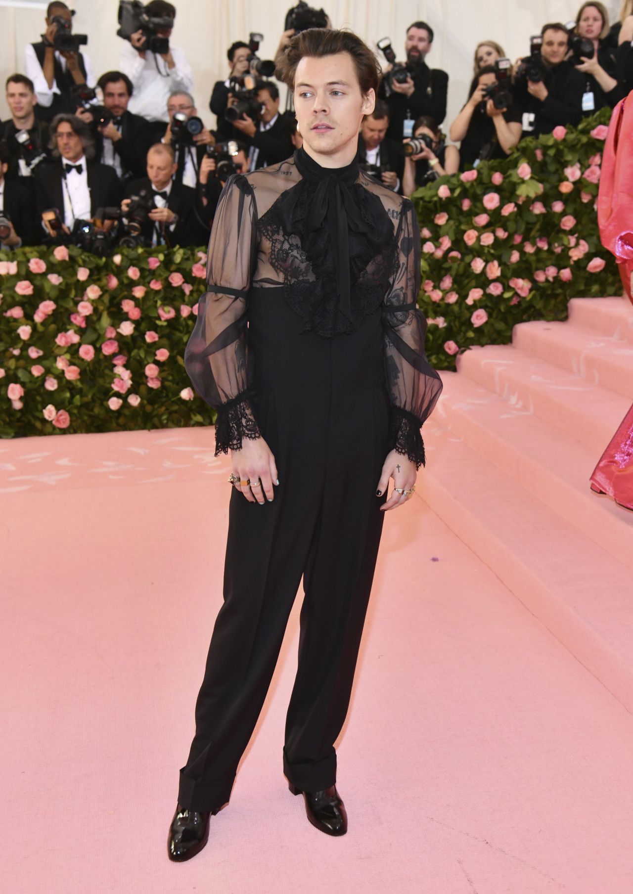 Harry Styles attends the Met Gala wearing Gucci.