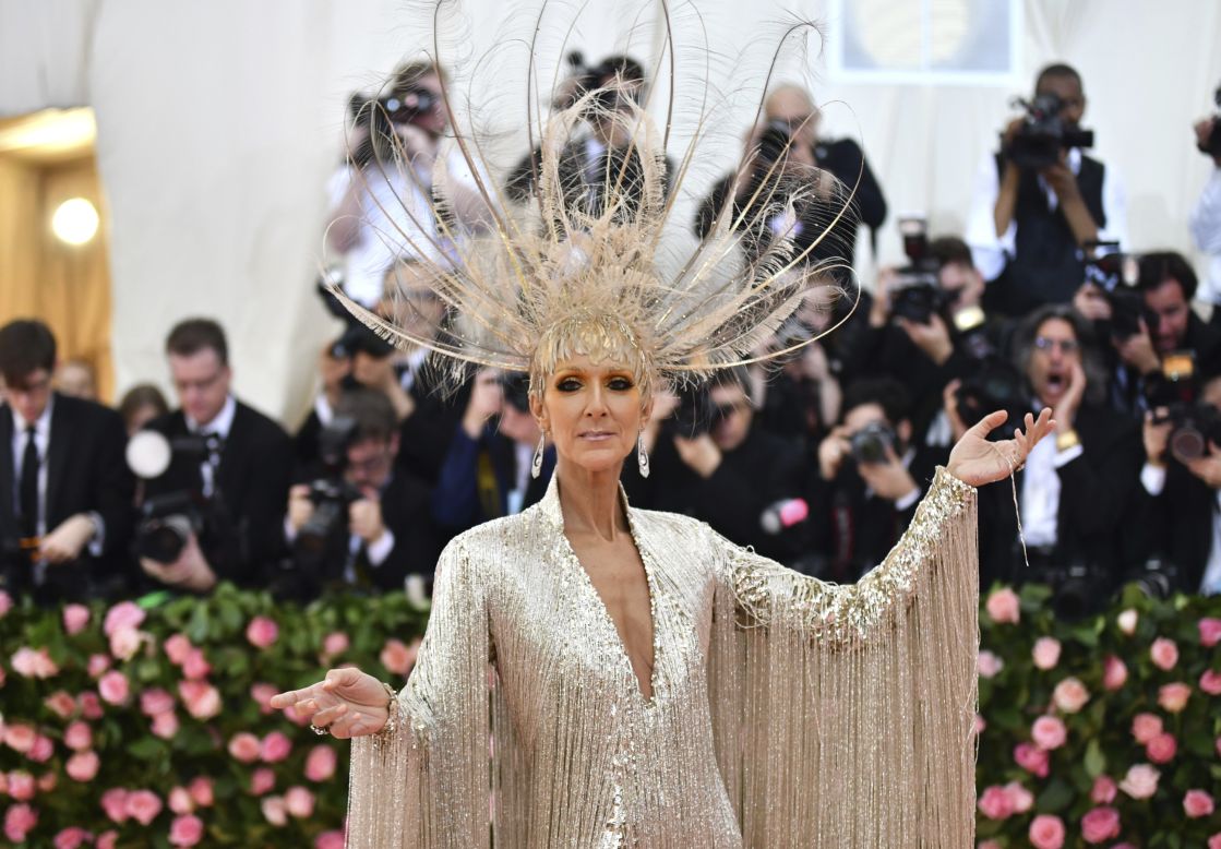 Celine Dion arrived in an elaborate gown and headpiece by Oscar de la Renta. The label said that it took 52 "master embroiderers" over 3,000 hours to hand-bead the 22-pound dress. 