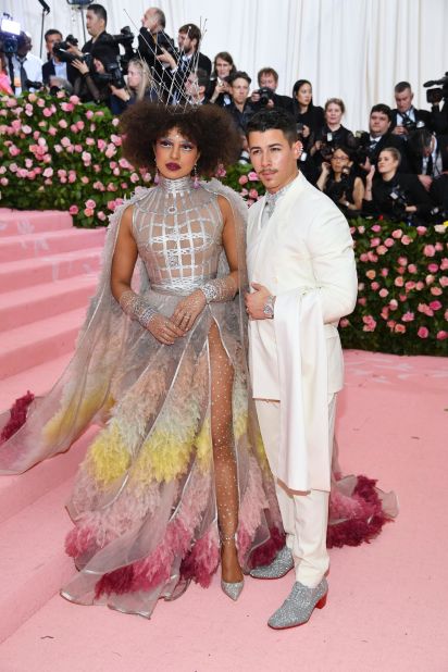 Last month, Nick Jonas told Entertainment Tonight that his wife Priyanka Chopra would "set the tone" for the pair's Met Gala outfits. The Bollywood star did just that, wowing onlookers in a stunning feather dress by Dior Haute Couture. Jonas complemented the look with silver shoes and a silver shirt peeking out from his Dior Men white suit. The Met Gala has a special place in the pair's romantic history: They made their first public appearance together at the 2017 event, which they attended as guests of Ralph Lauren.