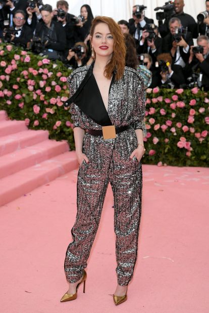 Emma Stone, who lit up red carpets during Hollywood's awards season, arrived in a glittery Louis Vuitton pantsuit.
