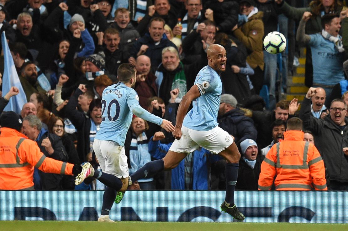 Vincent Kompany celebrates scoring in his side's dramatic victory over Leicester.