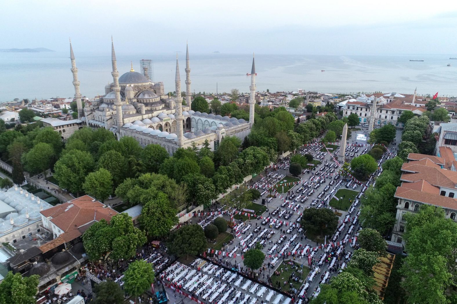 A drone photo shows thousands of people gather for iftar (fast-breaking) dinner during the Holy fasting month of Ramadan at Sultanahmet Square in Istanbul, Turkey on Monday, May 6.
