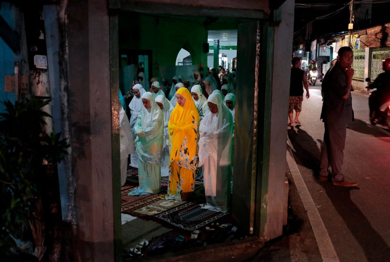 Muslim women perform an evening prayer called 'tarawih' during the first day of the fasting month of Ramadan at a mosque in Jakarta, Indonesia, Monday, May 6. Muslims around the world are observing Ramadan, the holiest month in the Islamic calendar.