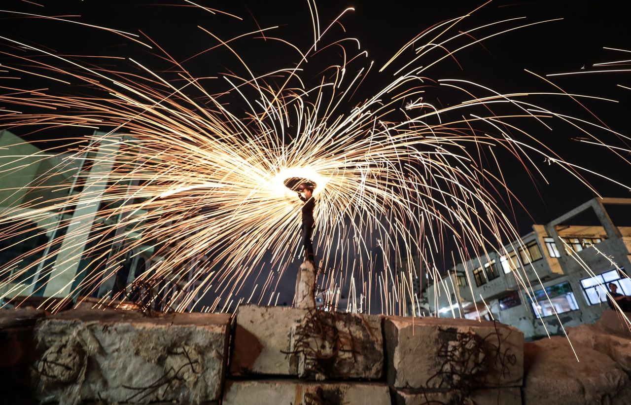Gazaian youth perform fire spinning during the holy month of Ramadan in Gaza City, Gaza on Monday.