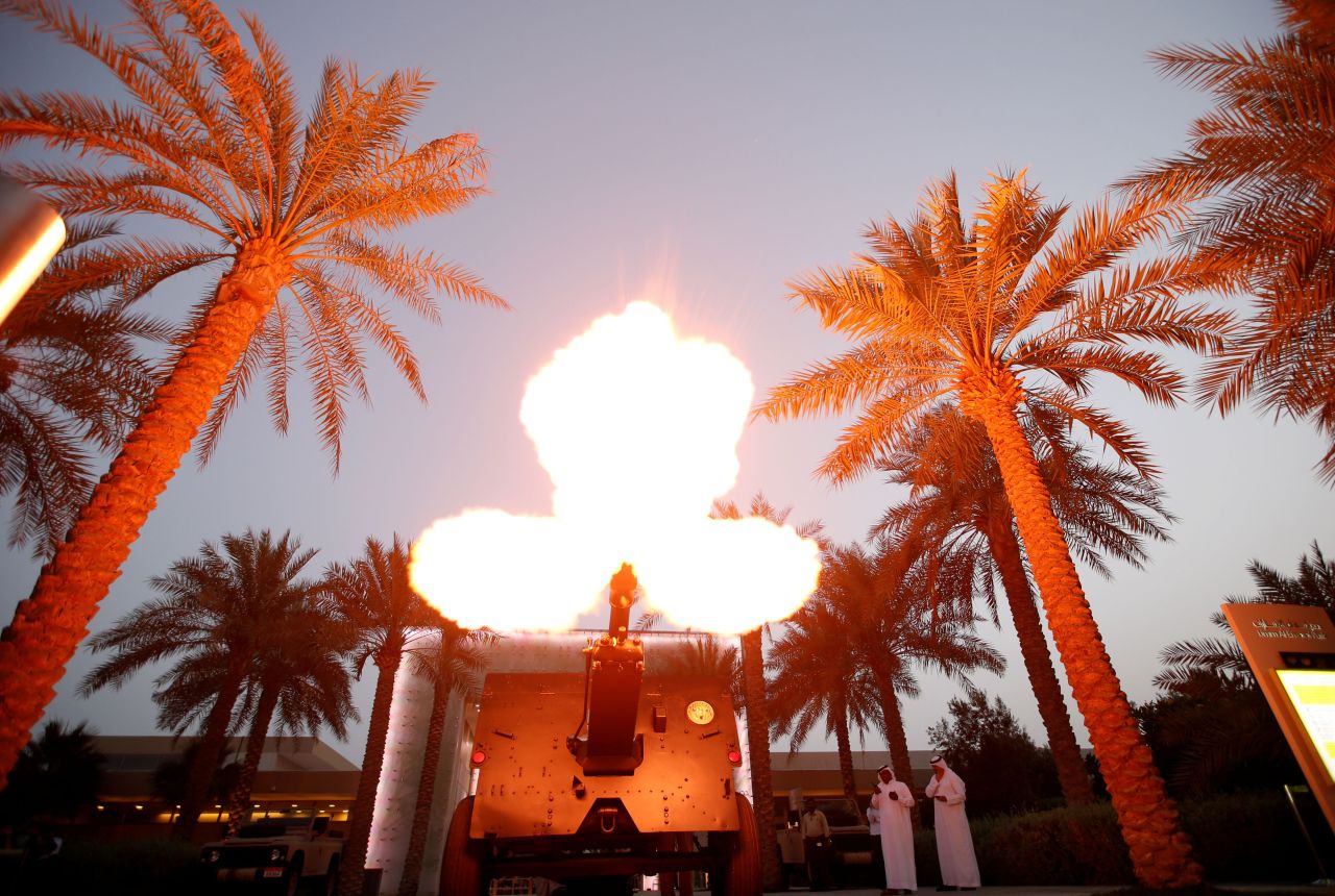 A UAE policeman fires a cannon salute as a signal for the end of the fasting day of Ramadan at Umm Al Emarat Park, Abu Dhabi, the United Arab Emirates on 6 May.