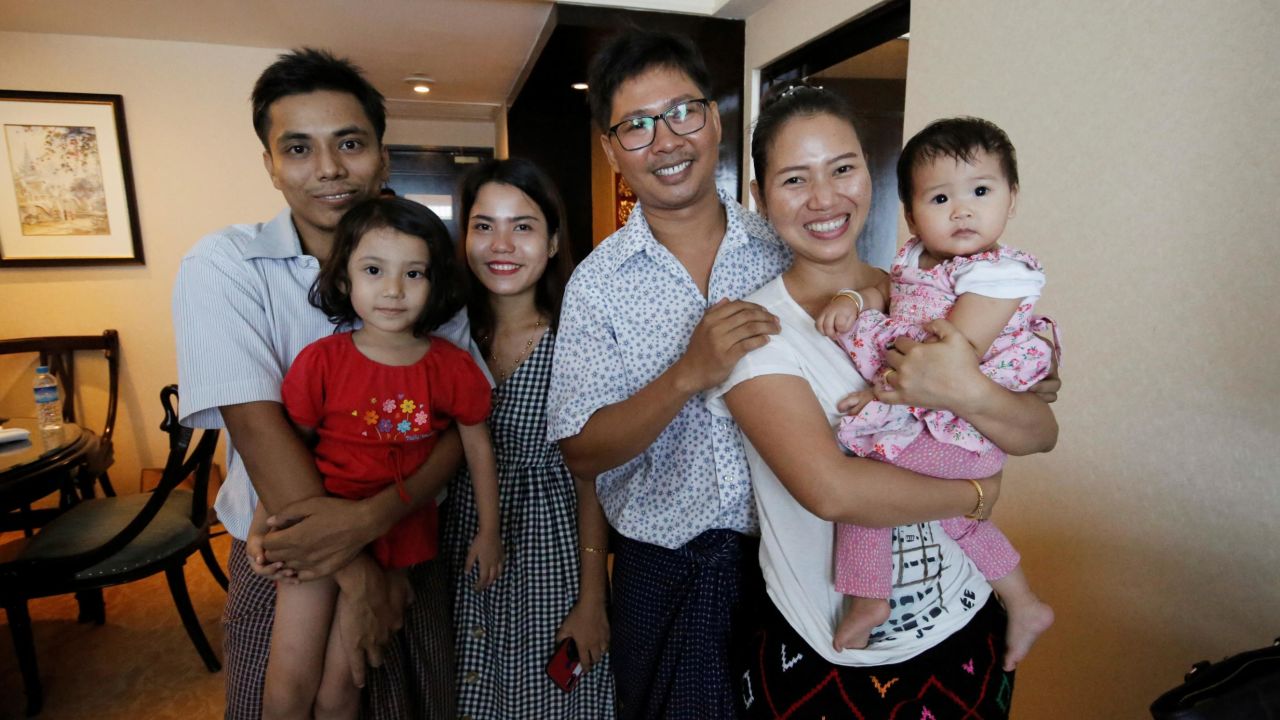 Wa Lone poses with his wife Pan Ei Mon and daughter, along with fellow reporter, Kyaw Soe Oo, carrying his daughter, next to wife Chit Su Win.