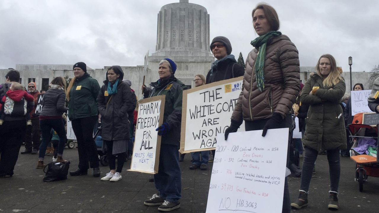 Hundreds of people, including families, attend a rally at the Oregon State Capitol protesting a proposal to tighten school vaccine requirements Thursday, March, 7, 2019, in Salem, Oregon.