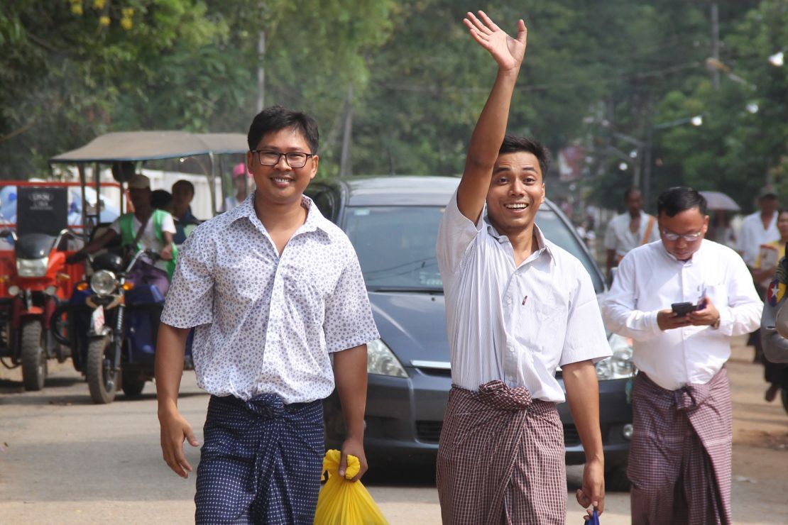 Reuters journalists Kyaw Soe Oo (right) waves beside colleague Wa Lone as they walk out of Insein prison after being freed in a presidential amnesty in Yangon on May 7, 2019. AFP/Getty Images