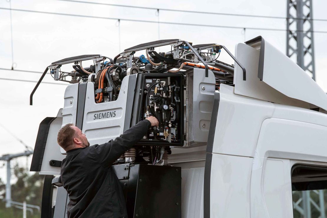 A technician works on a big rig before the tests commence. 